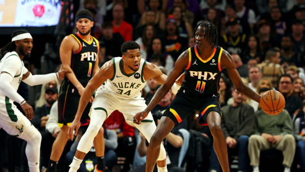 Phoenix Suns center Bol Bol (11) handles the ball against Milwaukee Bucks forward Giannis Antetokounmpo (34) during the first quarter at Footprint Center.